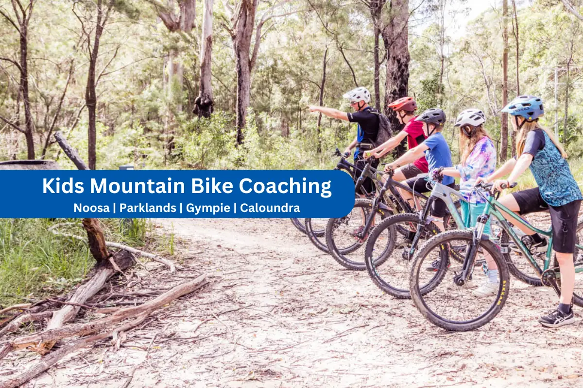 Qualified mountain bike coach showing directions to children in bike handling skills teaching class