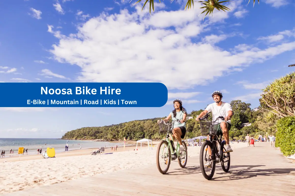Couple riding rental beach cruisers on Noosa main beach boardwalk